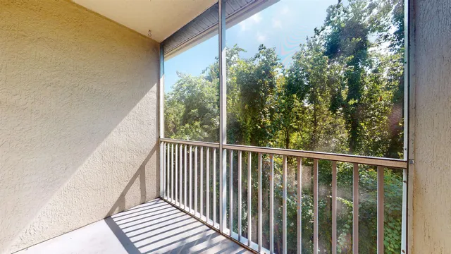 a view of a balcony with wooden floor
