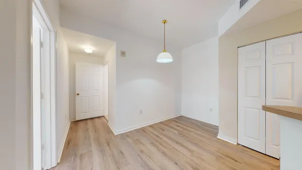a view of a room with wooden floor
