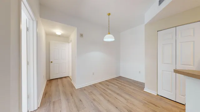 a view of a room with wooden floor