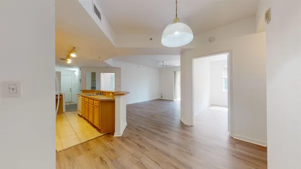 a view of kitchen and hall with wooden floor