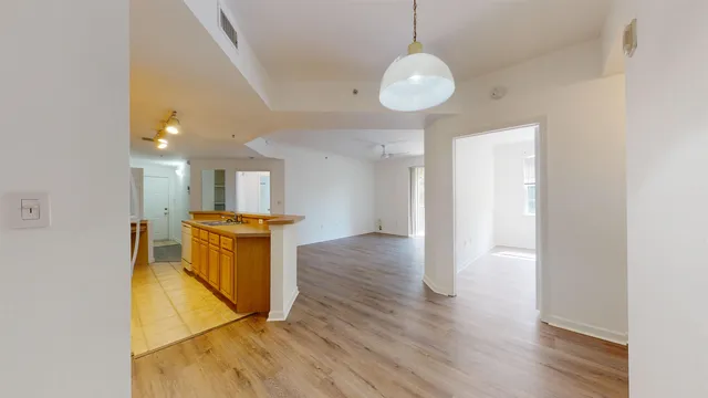 a view of kitchen and hall with wooden floor