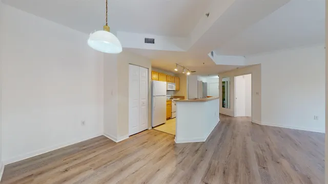 a view of a kitchen with wooden floor