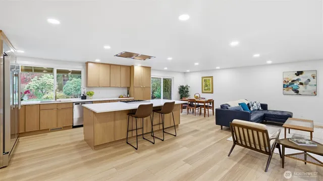 a kitchen with a table chairs and wooden floor