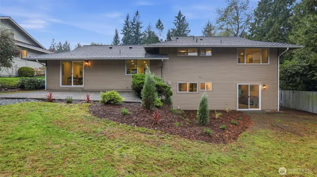 a view of a swimming pool with a yard and outdoor seating