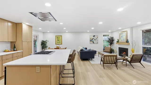 a view of a dining room with furniture a fireplace and wooden floor