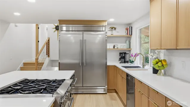 a kitchen with stainless steel appliances a refrigerator and sink