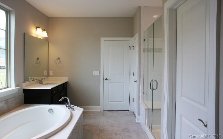 974 Emory Lane, Unit 111 Fort Mill, SC 29708 - Photo 12 of 22 a bathroom with a tub sink shower and mirror
