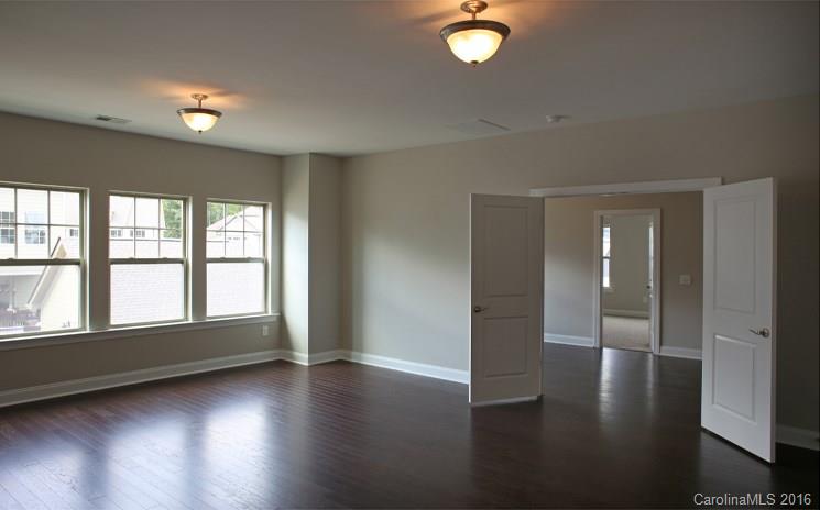 974 Emory Lane, Unit 111 Fort Mill, SC 29708 - Photo 14 of 22 an empty room with wooden floor and windows