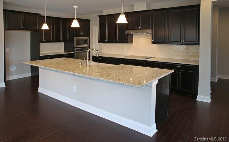 974 Emory Lane, Unit 111 Fort Mill, SC 29708 - Photo 4 of 22 a kitchen with kitchen island granite countertop a sink a stove and a refrigerator