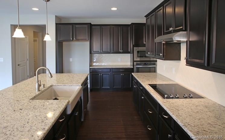 974 Emory Lane, Unit 111 Fort Mill, SC 29708 - Photo 6 of 22 a kitchen with stainless steel appliances granite countertop a sink stove and refrigerator