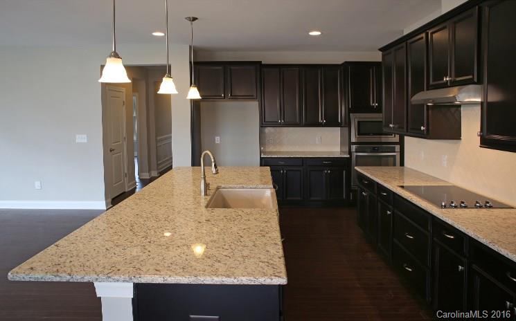 974 Emory Lane, Unit 111 Fort Mill, SC 29708 - Photo 7 of 22 a kitchen with stainless steel appliances granite countertop a sink a stove and a refrigerator