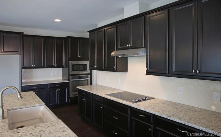 974 Emory Lane, Unit 111 Fort Mill, SC 29708 - Photo 9 of 22 a kitchen with stainless steel appliances granite countertop a refrigerator and a stove top oven