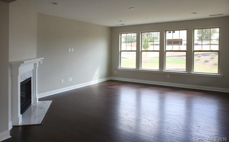974 Emory Lane, Unit 111 Fort Mill, SC 29708 - Photo 10 of 22 an empty room with wooden floor and fireplace