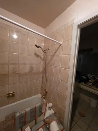 a bathroom with a tub and a shower