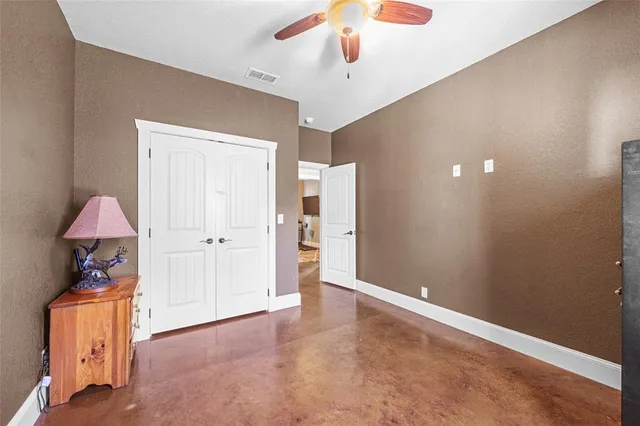 a view of an empty room with cabinet and a window