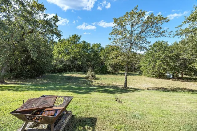 a view of a swimming pool with a yard
