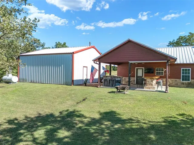 a view of a house with backyard porch and sitting area