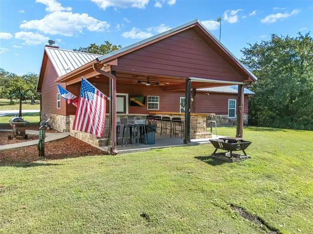 a view of a house with backyard porch and sitting area