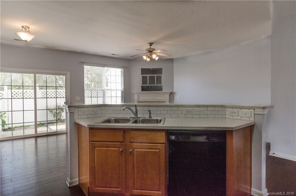 962 Copperstone Lane Fort Mill, SC 29708 - Photo 14 of 34 a kitchen with a granite countertop sink window and wooden floor