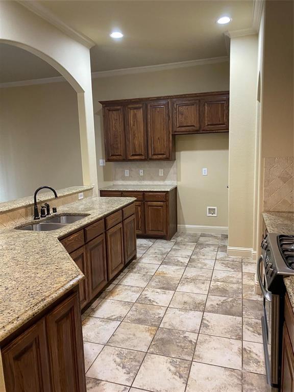 2222 Kirby Street Dallas, TX 75204 - Photo 23 of 25 Kitchen featuring rich wood cabinetry, granite countertops, tile flooring, and recessed lighting
