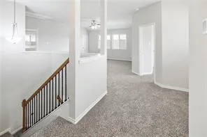 a view of a hallway with dining room and chandelier