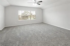 an empty room with windows and chandelier fan
