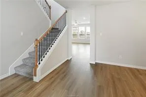 a view of entryway and hall with wooden floor