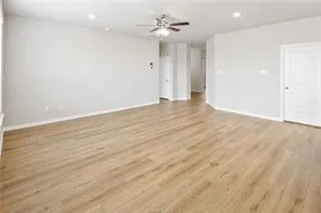 an empty room with fan and a ceiling fan