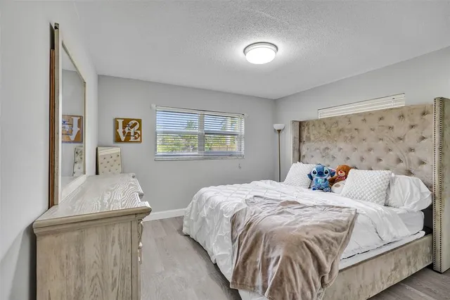 a bedroom with bed and window