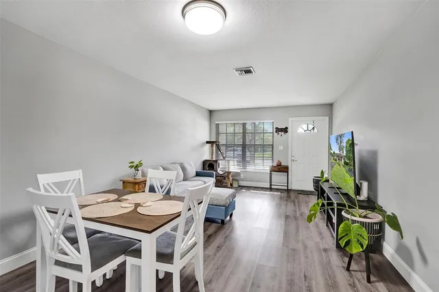 a kitchen with cabinets stainless steel appliances a sink and wooden floor