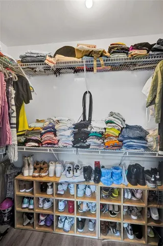 a bathroom with a sink a toilet a mirror and shower
