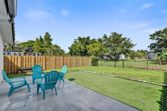 a view of a bench in the garden near a lake