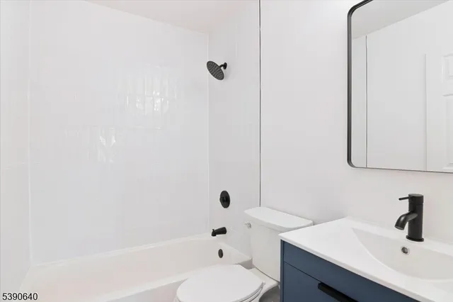 a bathroom with a bathtub shower sink and toilet
