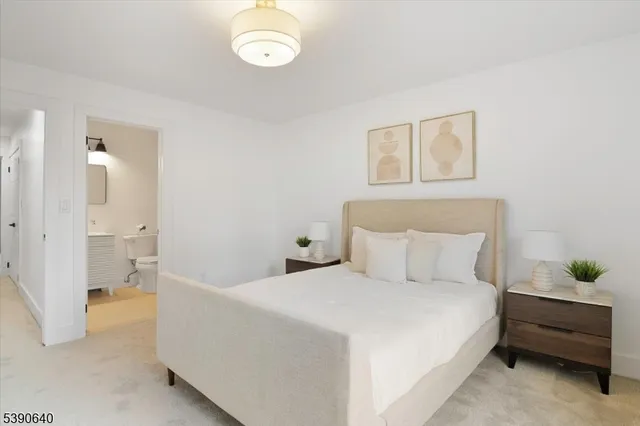 a bedroom with a bed and a painting on the wall