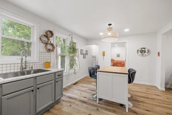 a kitchen with counter top space with wooden floor
