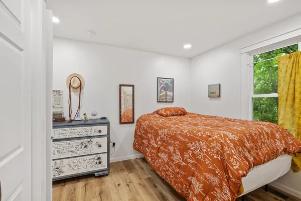 a bedroom with a bed and a dresser