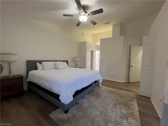 a bedroom with a bed and a ceiling fan
