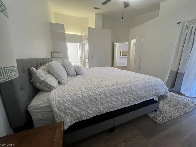 a large bed sitting in a bedroom and chair