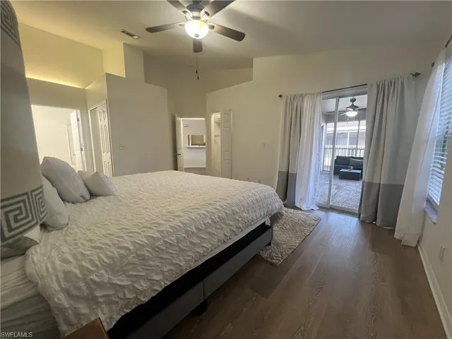 a spacious bedroom with a bed and a chandelier