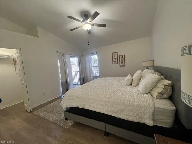 a bedroom with a large bed and a chandelier