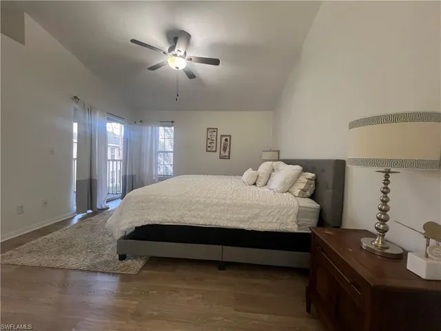 a spacious bedroom with a bed and a chandelier