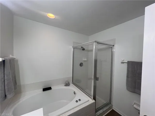 a bathroom with a tub and a shower