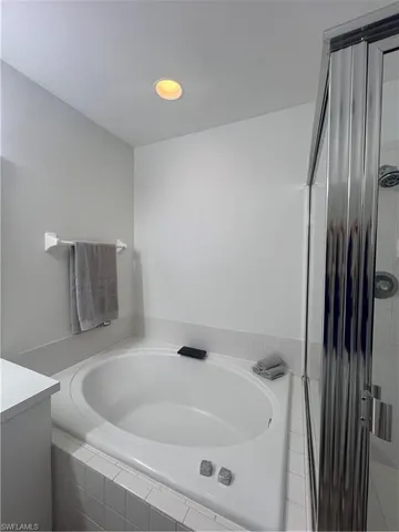 a bathroom with a tub and sink