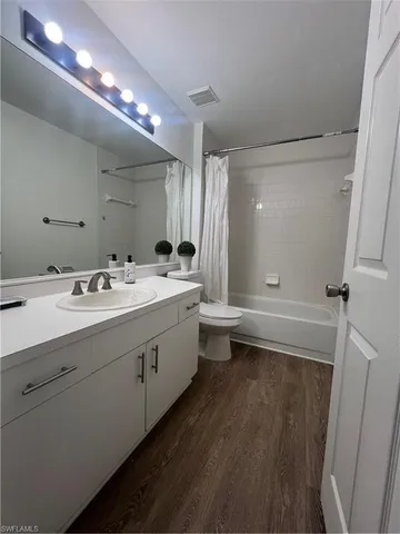a bathroom with a double vanity sink toilet and shower