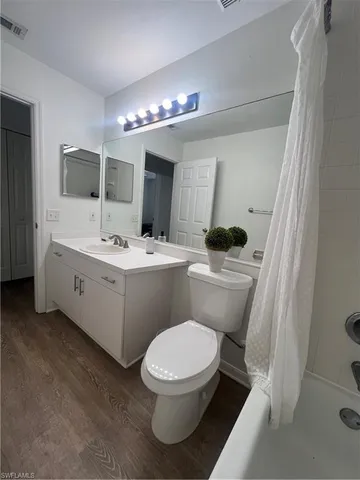 a bathroom with a sink a toilet a mirror and vanity
