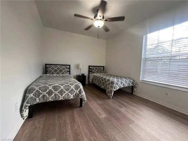 a bedroom with two beds and a chandelier
