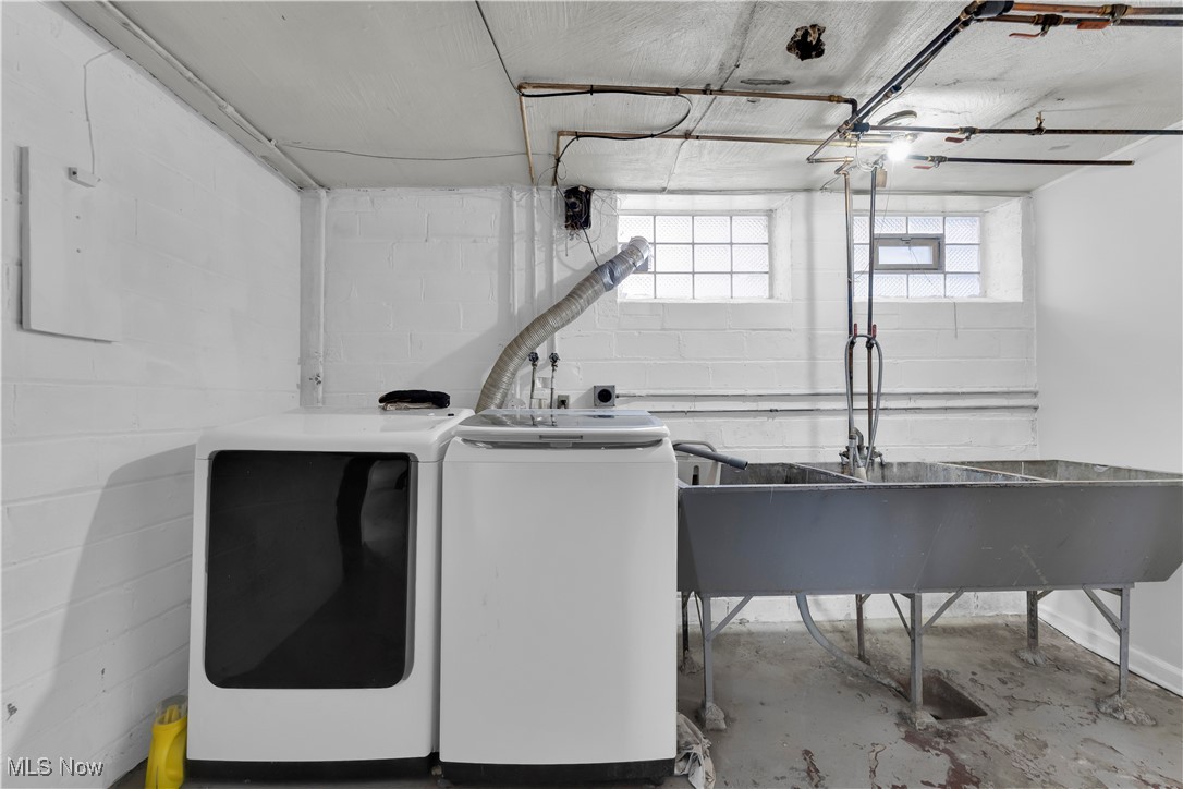 3739 Warren Road Cleveland, OH 44111 - Photo 6 of 40 Laundry area featuring washer and dryer and concrete flooring