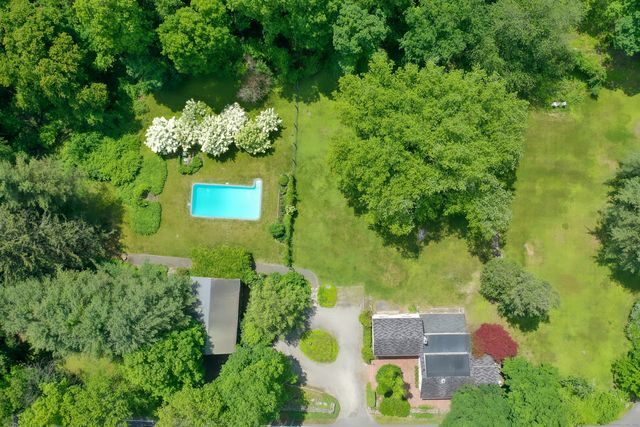 an aerial view of a house with a yard