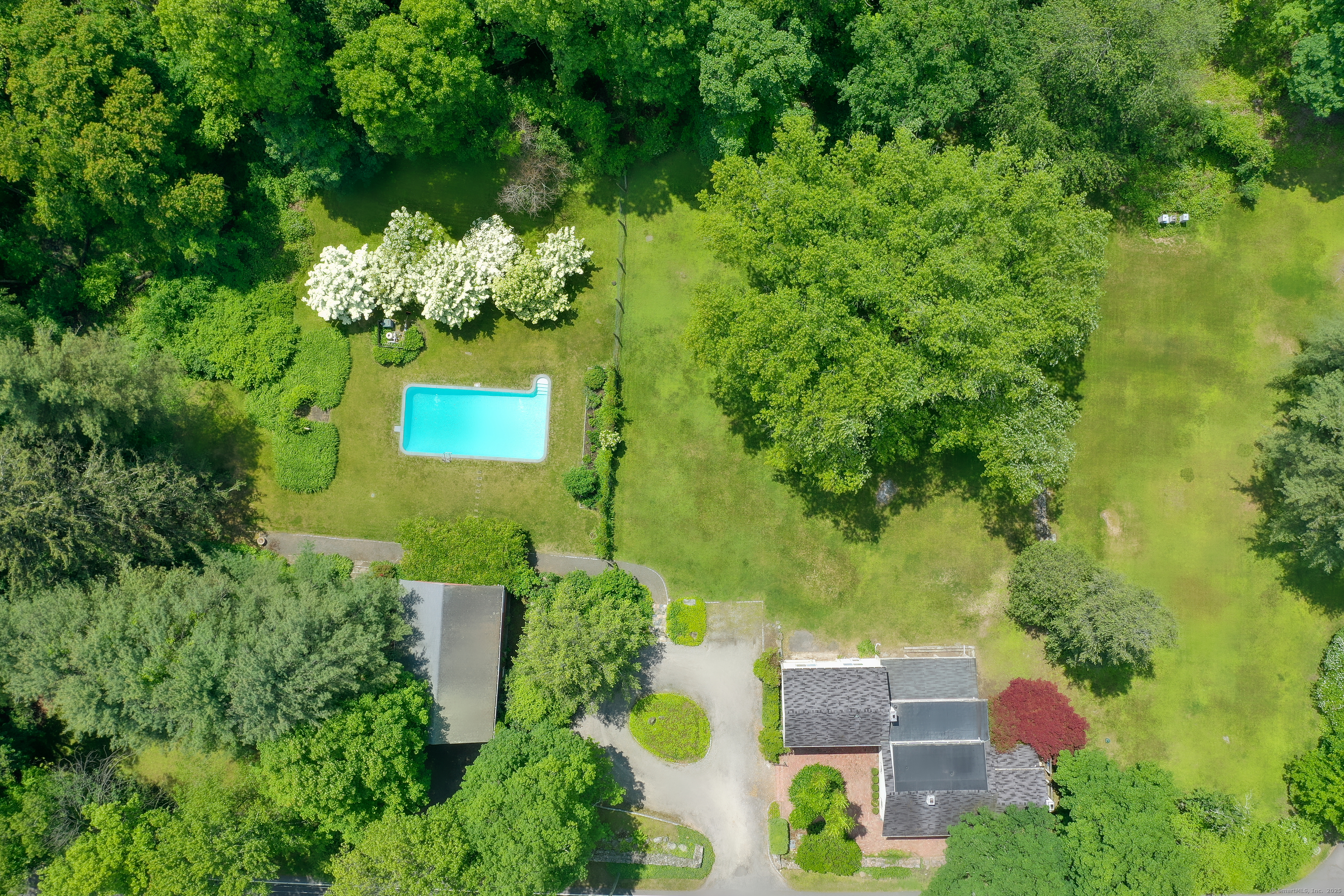 an aerial view of a house with a yard