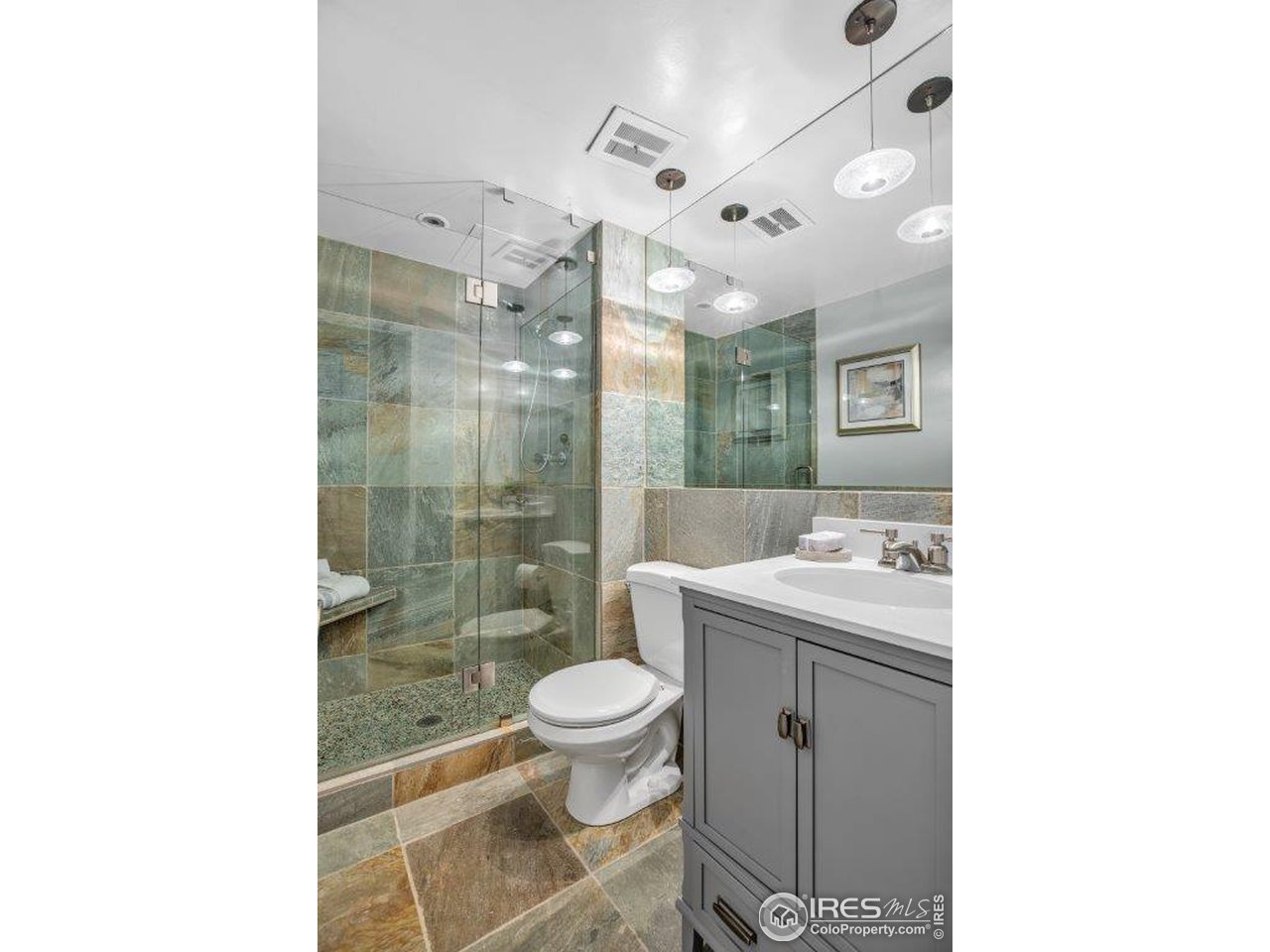 500 Mohawk Drive, Unit 103 Boulder, CO 80303 - Photo 12 of 28 a bathroom with a granite countertop sink a toilet a mirror and shower